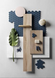 an arrangement of wood, tile and other items on a wall with blue hexagonal tiles