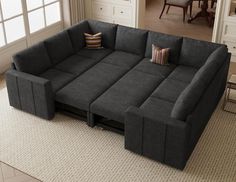 a large gray couch sitting on top of a rug