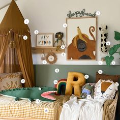 a child's bedroom with lots of pictures on the wall and toys in the bed