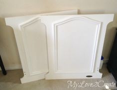 two white cupboards sitting next to each other in a room with carpeted flooring