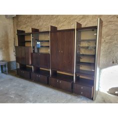 an empty room with several wooden cabinets in the middle and one on the other side