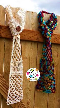 two crocheted ties hanging on a wooden fence