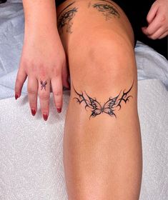 a woman's tattoo on her leg and the bottom part of her body is shown