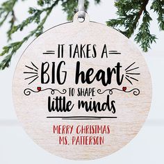 it takes a big heart to shape little minds christmas ornament hanging from a tree