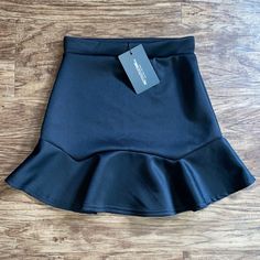 A Fun Twist On A Classic Black Mini Skirt Features: - Elasticized Waist - Trumpet Flare Party Ruffled Mini Skirt, Black Mini Hem Skort For Party, Plaid Tennis Skirt, Night Out Skirts, Matching Top And Skirt, Beach Maxi Skirt, Blue Jean Skirt, Blue Mini Skirt, Trumpet Skirt