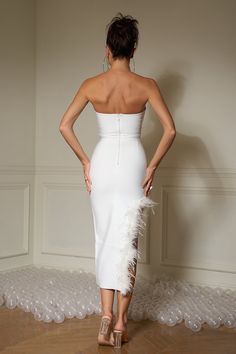 Try something daring and wild in our Leilani Stunning Feather White Dress! This showstopper features a strapless corset top and high-low flowing skirt with an eye-catching white feather embellished hem. Put it on and be the life of the party!   Model wearing size S  Model stats: Height-175cm/5'9" Bust-93cm/36.6" Waist-65cm/25.6 Hips-93cm/36.6"  Color may vary due to the lighting on images.  Item runs true to size chart and is cut to suit our size chart. Please refer to our size chart for the bes Strapless Feather Trim Wedding Dress, Strapless Wedding Dress With Feather Trim, Elegant Strapless Dress With Feather Trim, Strapless Dress With Feather Trim For Prom, Chic Strapless Dress With Feather Trim For Evening, Fitted Strapless Dress With Feathers, Elegant Strapless Dress With Feather Trim For Cocktail, Elegant Strapless Cocktail Dress With Feather Trim, Fitted Feathered Strapless Dress For Night Out