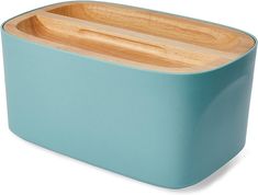 a blue container with two wooden spoons in it