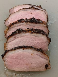 slices of meat sitting on top of a cutting board