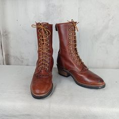 Great pair of packer, logger, work boots made by the Georgia Boot Company in the USA. Brown leather uppers with 11 rows of laces holes and hooks. 9 1/2 inches tall plus a 2 inch heel. Vibram soles. Very nice condition. Notice the picture of the solesvery little wear.  Stamped men's size 8 W (wide width).     Measurements: Sole length   11 inches Sole width     4 inches Vintage Lace-up Work Boots For Outdoor, Rustic Lace-up Boots For Outdoor, Rustic Lace-up Outdoor Boots, Rustic Lace-up Boots With Reinforced Toe, Vintage Lace-up Boots With Leather Sole For Outdoor, Rugged Round Toe Boots With Lacing, Western Leather Lace-up Combat Boots, Western Style Leather Lace-up Combat Boots, Western Style Lace-up Leather Combat Boots