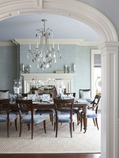 a dining room table with chairs and a chandelier