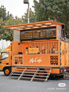 an orange food truck is parked on the street