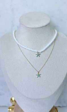 Dainty beaded necklace with small white seed beads and a dainty turquoise gem-paved gold starfish charm. Necklace is about 14 inches and includes a 2 inch extender. Starfish Necklace, Detail Shop, Starfish, Charm Necklace, Seed Beads, Beaded Necklace, Gems, Turquoise, Beads