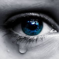 an eye with blue eyes and tears on it