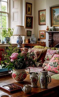 a living room filled with lots of furniture and flowers on top of a wooden table