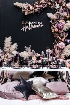 an assortment of decorative items are displayed on a table in front of a black backdrop