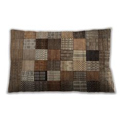 a brown and black patchwork pillow on a white background