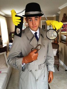 a man in a suit and hat holding a magnifying glass with rubber gloves on his head