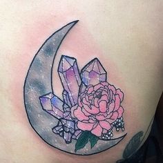 a woman's stomach with a rose and crystals on the moon behind her belly