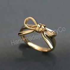 About Item  Item           :- Knot Tie Ring Ring size   :- Choose from variation( Custom size accepted) Material   :- Sterling silver Purity  :- 92.5 Item Title :- Silver Knot Bow Tie Ring, Dainty Ribbon Ring, Minimalist Band, Everyday Stacking Ring, Tiny bow Ring, Gift for Her, Bow Jewelry,Women's ring Description:- We use 925 sterling silver & 14K pure gold to making jewelry. We accept all types of custom & personalized order. Please send us a message if you are interested in a custom creation.  Shipping profile :- We ship all order within 3-5 days. But custom order takes time. Customer service:- If you have any question about our products & services, feel free to contact us. We do always best for our customers. Thanks & Regards, HandmadejeweleryCo. Round Bow Rings For Gift, Adjustable Anniversary Ring With Bow Detail, Adjustable Bow Ring For Anniversary, Bow Ring Jewelry For Gift, Gold Bow Ring For Anniversary, Gold Bow Rings For Wedding, Bow Tie Ring, Tie Ring, Ribbon Ring