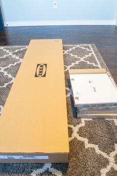 two boxes sitting on top of a carpeted floor next to each other in front of a blue door