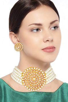 This jewellery set is crafted in 18k gold plated traditional light weight beaded choker set glided with moti work. The necklace feature beads & moti work in it and is secured with a drawstring closures. Style this necklace set with a saree or a salwar suit to enhance the look. Product Features:   Color: White and Gold Material: Alloy Necklace Length: 21 cm x Width - 3 cm Pendnat Width: 5.5 cm Earring Height: 2.3 cm x Width - 2.3 cm Product Weight: 58 gms Occasion: Wedding Disclaimer: There w Gold Choker Set, Moti Work, Traditional Light, Chocker Necklace, Choker Set, Traditional Lighting, Gold Choker, Jewellery Set, Salwar Suit