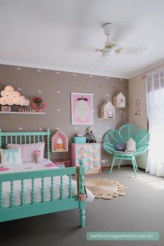 a child's bedroom decorated in pastel colors