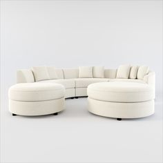 a white couch and ottoman with pillows on it