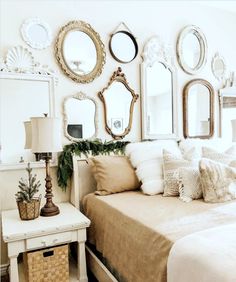 a bedroom with mirrors on the wall and pillows on the bed in front of it