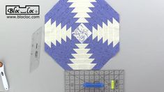 there is a blue and white quilt on the wall next to scissors, rulers and other crafting supplies