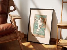 a chair sitting next to a framed art print