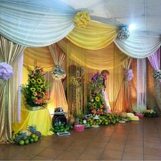 an elaborately decorated banquet hall with flowers and fruit on the floor, along with other decorations