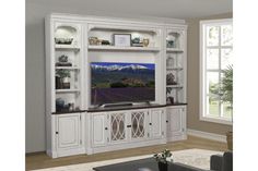 the entertainment center is white and has glass doors on each side, along with shelves