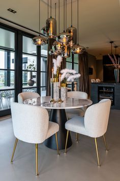 a dining room table with chairs and a chandelier