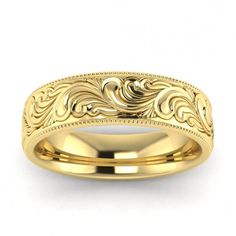 a gold wedding band with an intricate design