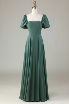 a green dress on a mannequin dummy with an open shoulder and puffed sleeves