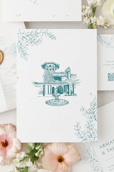 the wedding stationery is laid out on top of some flowers and paper with blue ink