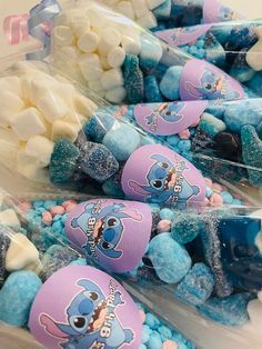 there are many candies in plastic bags with blue and white marshmallows