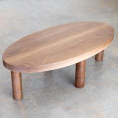 a wooden table sitting on top of a cement floor