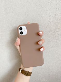 a woman's hand holding an iphone case