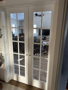 two glass doors in the middle of a room