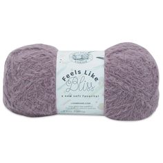 a ball of yarn with the words feels like bliss written on it in white and purple