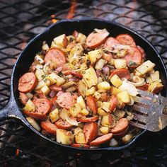 a skillet filled with lots of different types of food on top of a table