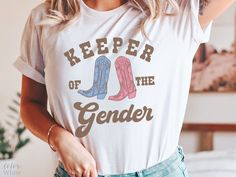 a woman wearing a t - shirt that says keeper of the genderer on it