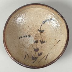 a small bowl with flowers painted on it