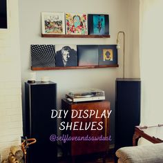 a living room filled with furniture and pictures on the wall above it is an old record player