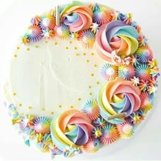 a white cake topped with lots of colorful icing