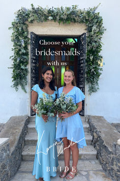 two women standing in front of a door holding flowers