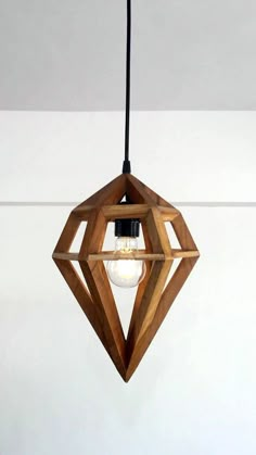 a wooden light fixture hanging from a ceiling