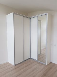 an empty room with white walls and wooden floors