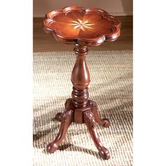 a small wooden table on top of a carpeted floor